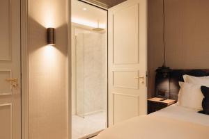a bedroom with a bed and a sliding glass door at Hotel 717 in Amsterdam