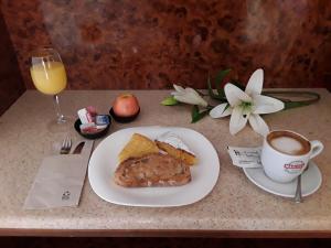 a table with a plate of food and a cup of coffee at Hotel Castro in Santiago de Compostela