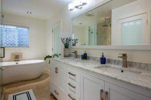 a bathroom with a sink and a bath tub and a mirror at Overlooking Marina del Rey sailboats, is Green Ginger Playa Del Rey on the bluff, in Los Angeles +98 photos