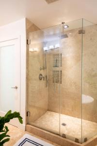 a shower with a glass enclosure in a bathroom at The Green Ginger Guest House in Los Angeles