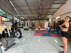 a woman exercising in a gym with a man at Jungle Gym & Ecolodge in Haad Rin