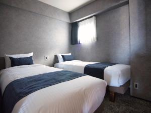 Кровать или кровати в номере ulu Tokyo
