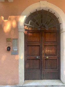 - une grande porte en bois sur le côté du bâtiment dans l'établissement Incantevole mini appartamento in centro a Padova., à Padoue
