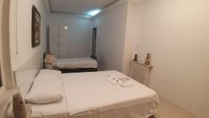 a small room with two beds in it at Görkemli Hotel in Istanbul