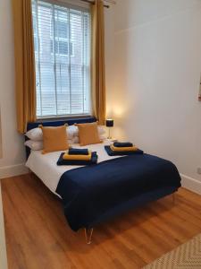 a large bed in a room with a large window at One Bedroom Flat Central Ipswich in Ipswich