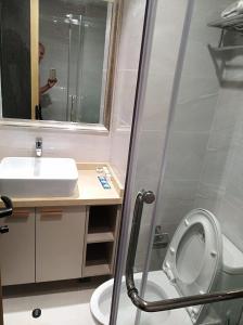 a bathroom with a sink and a toilet and a mirror at Apartments in Star Bay with sea view in Sihanoukville