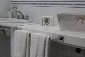 a bathroom with a sink and towels on a counter at Chez Les Sœurs in Pompei