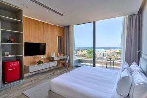 A bed or beds in a room at The G Hotel Seashell