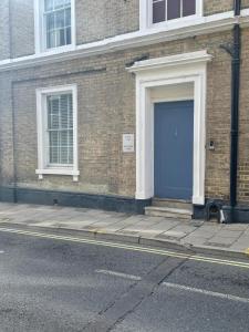 niebieskie drzwi na boku budynku z cegły w obiekcie One Bedroom Flat Central Ipswich w mieście Ipswich