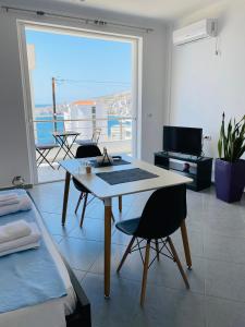 a living room with a table and a view of the ocean at TERRACE VIEW APARTMENTS in Sarandë