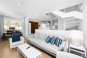 een witte woonkamer met een witte bank en stoelen bij Solaga - Carmen Beach in Málaga