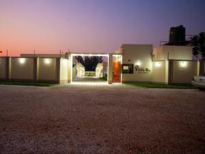 a driveway leading to a garage at night at Pebble View Luxury Apartments in Lusaka