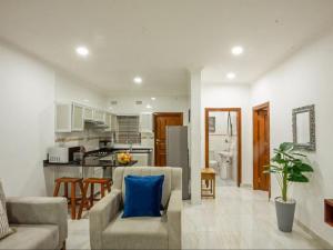 a living room and kitchen with a couch and a table at Pebble View Luxury Apartments in Lusaka