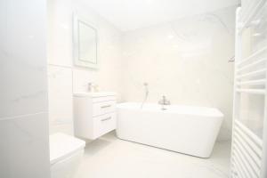 a white bathroom with a sink and a toilet at Waterloo warehouse in Liverpool