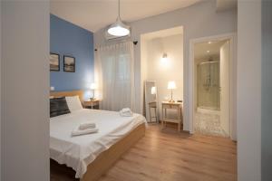 a bedroom with a bed and a bathroom with a shower at Exclusive apartment in the heart of Athens in Athens
