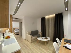 a living room with a couch and a table at Olea Suites 1 in Nea Moudania