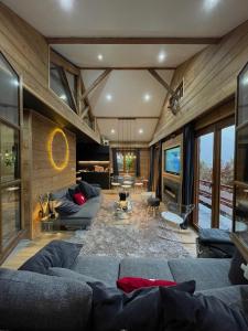 a living room with blue couches in a room at CHALET MONT BLANC in Combloux