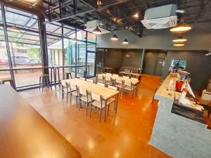 a room with tables and chairs in a building at Room@Doze in Nonthaburi