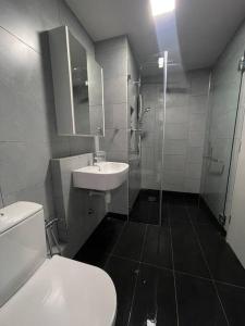 a bathroom with a toilet and a sink and a shower at Jesselton Quay,2BR,4-5pax,Mountain view in Kota Kinabalu