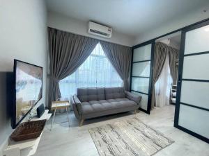 a living room with a couch and a large window at Jesselton Quay,2BR,4-5pax,Mountain view in Kota Kinabalu