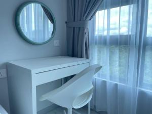 a white dressing table with a mirror and a chair at Jesselton Quay,2BR,4-5pax,Mountain view in Kota Kinabalu