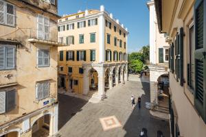 an empty street in an old city with buildings at Vittori Corfu Rooms in Corfu