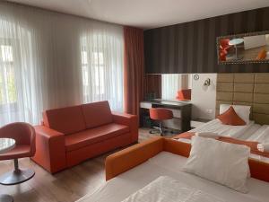 a bedroom with a bed and a couch and a desk at VIP Apartments in Bratislava