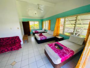 a large room with two beds and a couch at Sunny Beach Lodge in Amuri