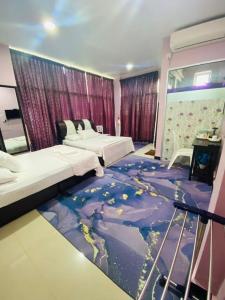 a bedroom with two beds and a world mural on the floor at Paka Tamim Seaview Hotel in Paka