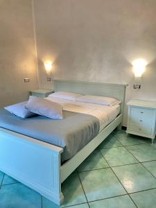 a bedroom with a large bed with two night stands at Costa Sud Salerno in Salerno