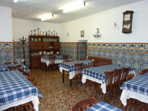 a restaurant with blue and white tables and chairs at Pensión Fonda Vilalta in Ribes de Freser