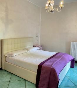 a bedroom with a bed with a purple blanket on it at Costa Sud Salerno in Salerno