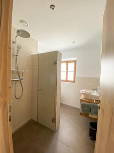 a bathroom with a shower and a sink at Ferienwohnungen Heillinger Gütl in Ruhpolding