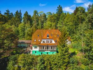 a large house in the middle of a forest at Jägerhaus Donaueschingen in Donaueschingen