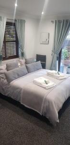 a large bed in a bedroom with a window at Room on the River in Cruden Bay