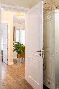 a room with a white door and a potted plant at Hotel Rural Ohana in Santa Cruz de Tenerife