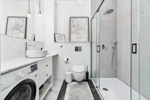 a bathroom with a sink and a washing machine at Family Apartment - 74m2 - Wapienna by Renters in Wrocław