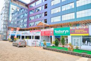 a car parked in front of a building at Legon City Mall Short Stay Apartments for Business and Vacation - East Legon in Accra
