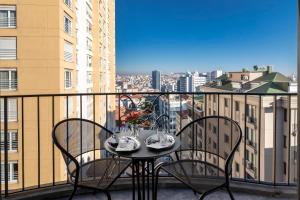 a table and chairs on a balcony with a view at Wish More Hotel Şişli in Istanbul