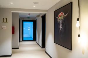 a hallway with a painting of a moose on the wall at Black F Tower - Serviced Apartments in Freiburg im Breisgau