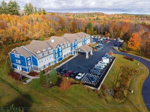 an aerial view of a large building with a parking lot at Comfort Inn & Suites Wilton in Wilton