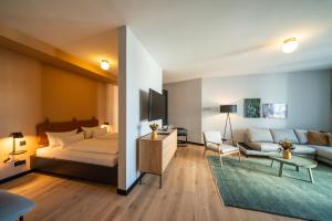 弗莱堡Black F Tower - Serviced Apartments的一间带床的卧室和一间客厅