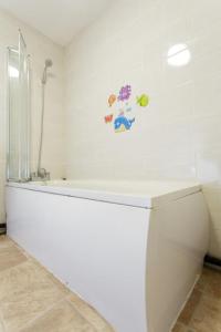 a bathroom with a white tub and a toilet at Brown house in Leeds in Leeds