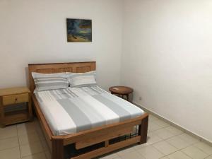 a bedroom with a bed in a room at OCEAN-SI Mansion in Kribi