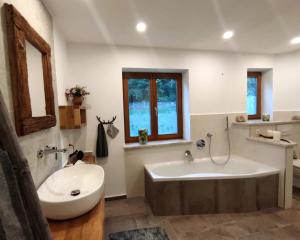 a large bathroom with a tub and a sink at TraunZeit in Siegsdorf