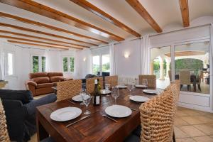 a dining room with a wooden table and chairs at Anngo in Jávea