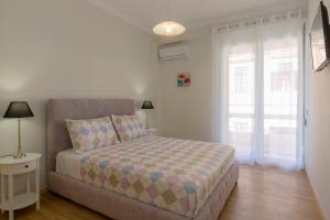 A bed or beds in a room at The Bright Suite