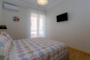 A bed or beds in a room at The Bright Suite