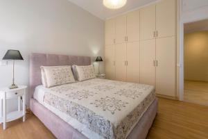 A bed or beds in a room at The Bright Suite