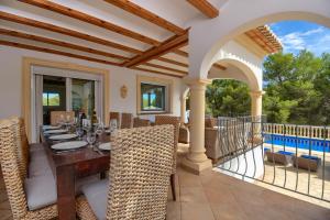 a dining room with a table and chairs on a patio at Anngo Dos in Jávea